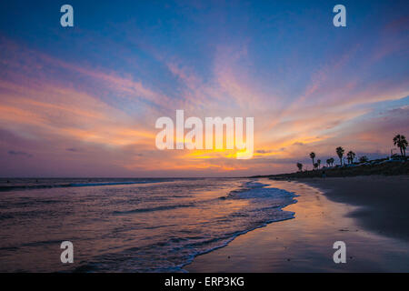 Bold blue et orange mark coucher du soleil sur une plage de l'océan tropical. Banque D'Images