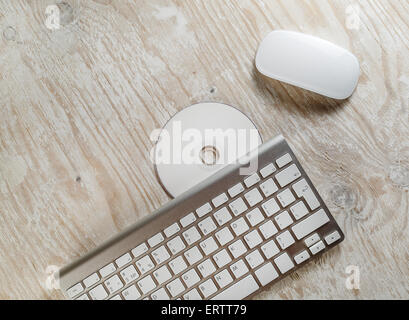 Table en bois bureau avec ordinateur, clavier et souris sans fil et blanc version CD. Vue d'en haut. Banque D'Images