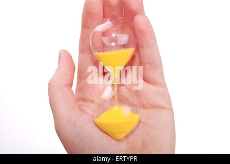 La femelle est titulaire d'une main en verre de sable avec du sable de couleur d'or Banque D'Images