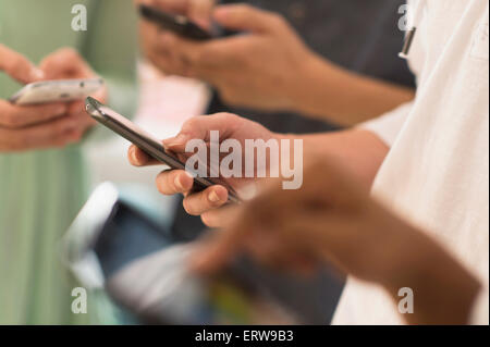 Close up of hands texting on cell phones Banque D'Images