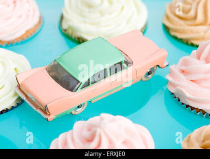 Dinky Plymouth Plaza voiture jouet entouré de gâteaux de tasse glacés dans les couleurs pastel Banque D'Images