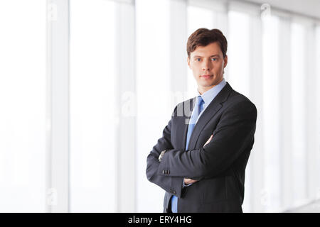 Portrait of handsome businessman in office windows Banque D'Images