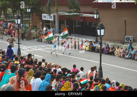 Touristes tenant des drapeaux de l'Inde et en cours d'exécution , Attari , frontière de Wagah , Wahga , Wagha , Wahgah , Amritsar , Punjab , Inde , Asie Banque D'Images