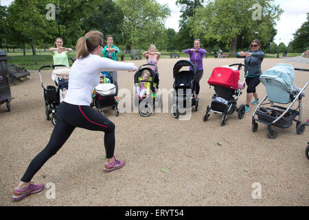 La mère de prendre un cours de conditionnement physique avec les bébés et les tout-petits dans leurs poussettes dans un parc à Londres, Angleterre, RU Banque D'Images