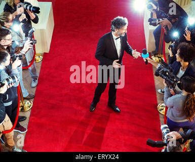 Celebrity sur tapis rouge d'être interviewé et photographié par les paparazzi Banque D'Images