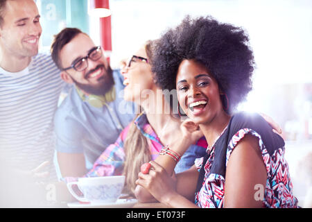 Portrait of laughing woman hanging out with friends in cafe Banque D'Images