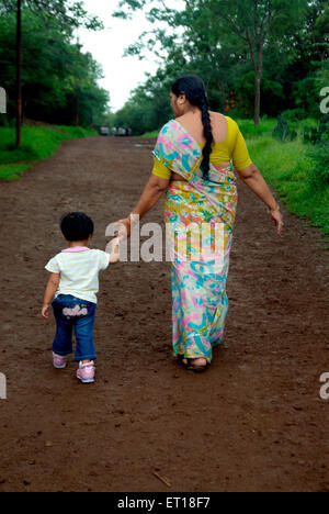 Indian grandmother and grandson walking in garden holding hands - M.# 364 Banque D'Images
