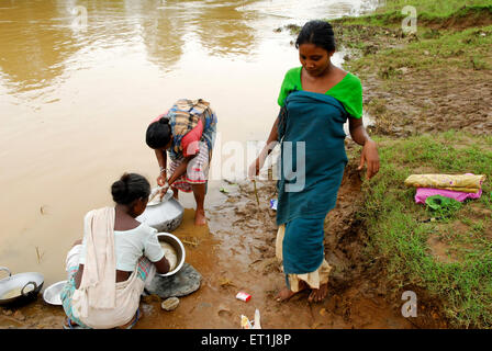 Les femmes lavant des pots dans la rivière, la tribu Ho, les gens tribaux, Chakradharpur, Singhbhum Ouest, Jharkhet, Inde, Asie Banque D'Images