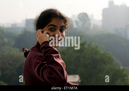 A girl talking on mobile phone in Pune Maharashtra Inde matin d'hiver Asie MR n° 1911 Banque D'Images