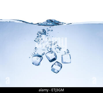 La chute des cubes de glace dans les projections d'eau isolé sur fond blanc Banque D'Images