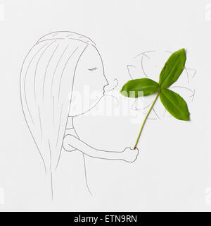 Conceptual girl blowing pinwheel une Banque D'Images