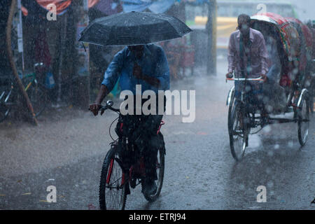 Dhaka, Bangladesh. 15 Juin, 2015. Un homme équitation location lors de fortes pluies à Dhaka. Zakir Hossain Chowdhury Crédit : zakir/Alamy Live News Banque D'Images