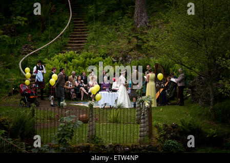 Une fête de mariage à l'extérieur ; les mariés échangent leurs vœux devant leurs invités du mariage à un autre emplacement Banque D'Images