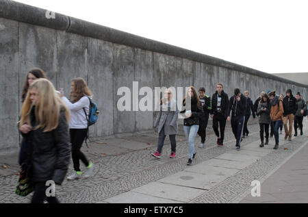 Berlin, Allemagne, les adolescents passent devant une partie de l'ancien mur de la frontière Banque D'Images