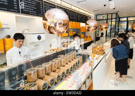 Personnel de la nouvelle pâtisserie ''Dominique Ansel Bakery'' prendre des commandes à partir de la presse membres durant la phase pré-événement d'ouverture pour la première boulangerie magasin japonais situé dans Omotesando Hills le 17 juin 2015, Tokyo, Japon. La nouvelle marque est connue pour ses pâtisseries Cronuts ; un croissant doughnut création fusion par le Chef Dominique Ansel et est déjà très populaire à New York. C'est la première fois qu'il ouvrira une succursale internationale. Le Japon a connu un boom récent dans les détaillants alimentaires surtout d'essayer d'être la dernière nouvelle tendance à Tokyo. Le magasin ouvre ses portes à la population le Ju Banque D'Images