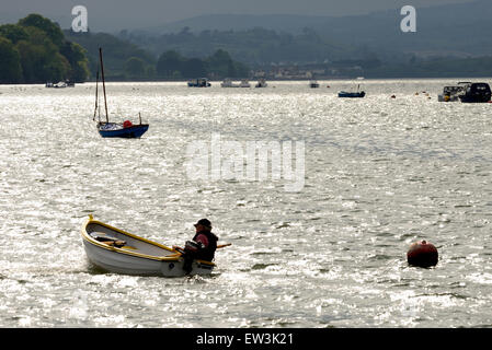 L'homme dans un petit bateau sur l'estuaire de la rivière Teign. Banque D'Images
