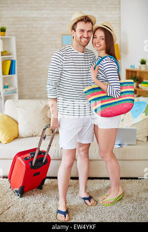 Jeune couple prêt à voyager looking at camera Banque D'Images