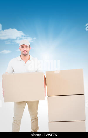 Composite image delivery man holding cardboard box Banque D'Images