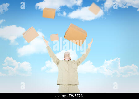 Image composite de delivery man with arms raised looking up Banque D'Images