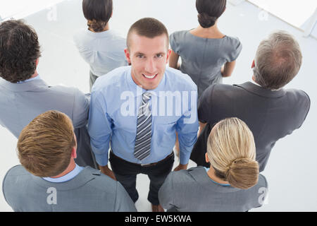Businessman looking at camera et business team standing back to camera Banque D'Images