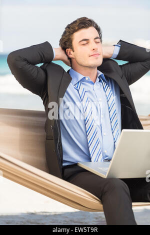 Businessman relaxing on hammock Banque D'Images