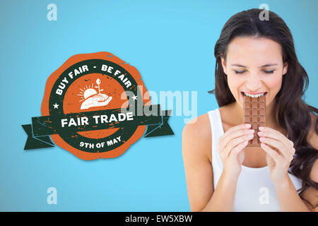 Image composite de jolie brunette eating barre de chocolat Banque D'Images