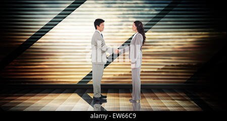 Image composite de business people shaking hands Banque D'Images