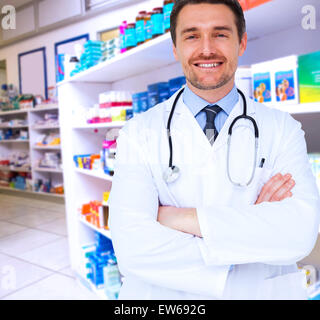 Image composite de handsome young doctor with arms crossed Banque D'Images