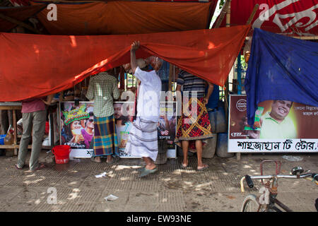 Dhaka, Bangladesh. 20 Juin, 2015. Extracteur de pousse-pousse et le travail journalier de manger des aliments de suspendre les bâches tea stall sur street à Dhaka durant le Ramadan. Pendant le mois sacré du Ramadan la plupart des stands de thé et restaurants suspendre les bâches de protection pour ceux qui ont besoin de manger et boire. Rickshaw Wallahs travaillent dur et ont besoin de leur énergie, et il y a des gens d'autres religions qui n'a pas jeûné pendant ce temps. Zakir Hossain Chowdhury Crédit : zakir/Alamy Live News Banque D'Images