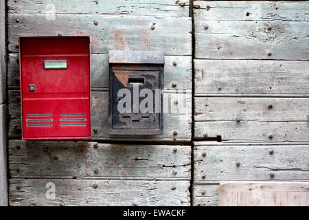 Ancienne et Nouvelle boîte aux lettres sur une porte en bois Banque D'Images