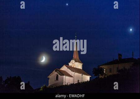 Fechy, Suisse 20 Juin. Une conjonction de Vénus, Jupiter et la Lune dans le ciel du soir sur Fechy église. Dans les nuits suivantes Vénus et Jupiter vont se rapprocher jusqu'à leur concert le 30 juin Crédit : Alistair Scott/Alamy Live News Banque D'Images