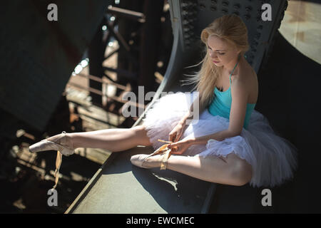 Ballerine assise sur le bord du pont Banque D'Images