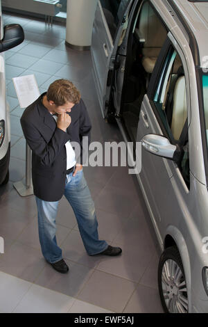 Man nouvelle voiture à la salle d'exposition Banque D'Images