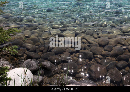 Les reflets du soleil sur un lac limpide marge dans les Montagnes Rocheuses Banque D'Images
