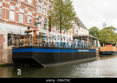 Bateaux amarrés le long d'un canal à la Haye, utilisés par les restaurants d'augmenter d'un coin salon. Banque D'Images