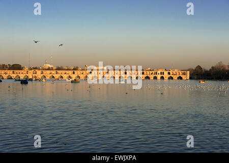 Activités au coucher du soleil Si-O Seh Pol, rivière Zayandeh, Isfahan, Iran Banque D'Images