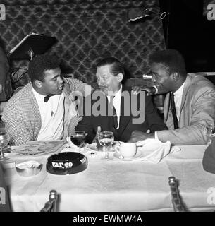 Cassius Clay alias (Muhammad Ali) répond à Peter Wilson (centré) à Isow's restaurant à Soho en avance sur son premier combat avec Henry Cooper. 26 Mai 1963 Banque D'Images