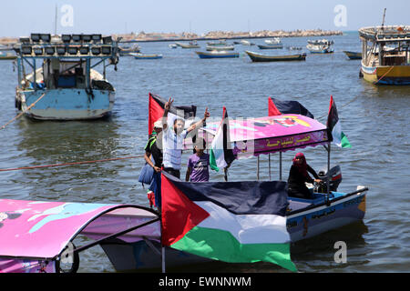 Gaza, la Palestine. 29 Juin, 2015. Palestiniens équitation bateaux tenir des drapeaux palestiniens au cours d'une manifestation contre le blocage israélien d'un bateau de militants étrangers d'atteindre Gaza, au port de la ville de Gaza. © Ibrahim Khatib/Pacific Press /Alamy Live News Banque D'Images