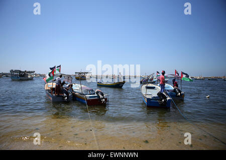 Gaza, la Palestine. 29 Juin, 2015. Palestiniens équitation bateaux tenir des drapeaux palestiniens au cours d'une manifestation contre le blocage israélien d'un bateau de militants étrangers d'atteindre Gaza, au port de la ville de Gaza. © Ibrahim Khatib/Pacific Press /Alamy Live News Banque D'Images