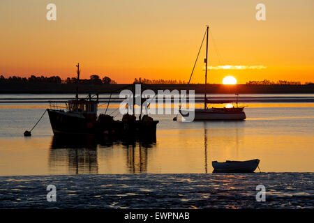 L'estuaire de Swale, Kent, UK. 30 Juin 2015 : la météo. Une lueur orange magnifique lorsque le soleil se lève dans un ciel clair matin calme, plus de bateaux amarrés dans la rigole de Harty ferry près de l'estuaire. L'air chaud de l'Afrique est réglé pour balayer vers le nord et prendre la température plus de 30°C le Mercredi avec des gens avertis de rester à l'intérieur Photo : Alan Payton/Alamy Live News Banque D'Images