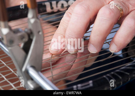 Raquette de tennis dans la machine en réparation de filets Banque D'Images