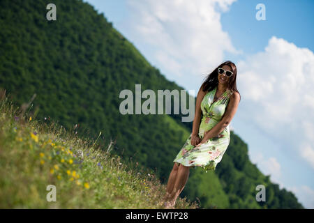 Jeune femme en tenue debout sur l'herbe Banque D'Images