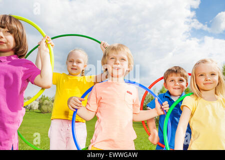 Close-up of children holding hula hoops in park Banque D'Images