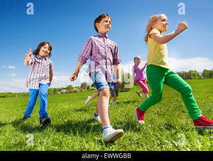 Vue de dessous d'enfants courir dans le parc Banque D'Images