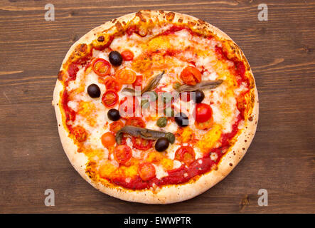 Pizza aux anchois et olives sur une table en bois Vue de dessus Banque D'Images