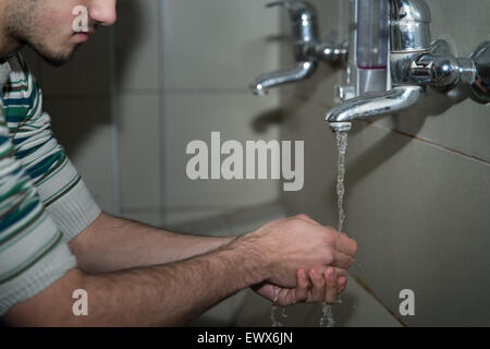 L'homme musulman se prépare à exercer dans la mosquée d'ablution Banque D'Images