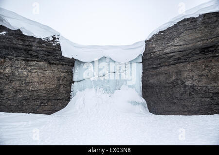 Vue sur cascade gelée entre rock, Svalbard, Norvège Banque D'Images