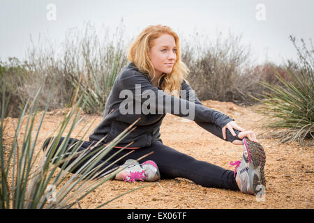 Young female runner stretching pour toucher les orteils Banque D'Images