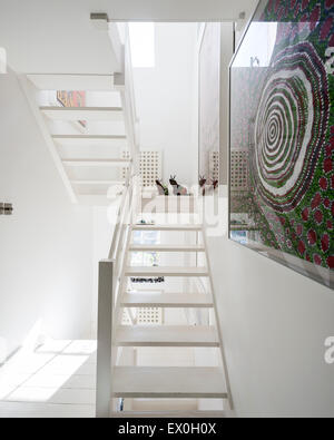 Escalier en bois blanc avec l'art par la Colline Spinifex artistes sur le mur Banque D'Images