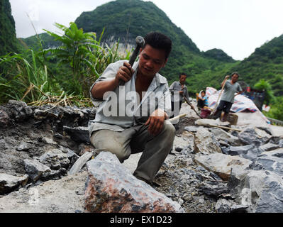 "Liutong, la région autonome Zhuang du Guangxi. 4 juillet, 2015. Les villageois de réparer une route endommagée à Liuye Canton de "Liutong Yao comté autonome de la Chine du Sud, région autonome Zhuang du Guangxi, le 4 juillet 2015. Les populations locales ont commencé leurs travaux de reconstruction récemment après une grave inondation qui a balayé le comté le 14 juin. Credit : créatrice Ailin Zhang/Xinhua/Alamy Live News Banque D'Images